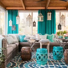 a living room filled with lots of furniture and decor on top of a blue floor