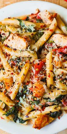 a white plate topped with pasta and chicken