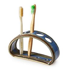 two toothbrushes in a holder on a white background