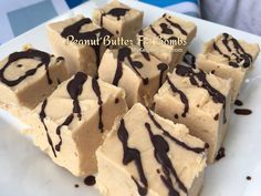 a white plate topped with pieces of cake covered in chocolate