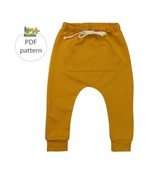 a small child's yellow sweat pants with white drawstrings on the bottom