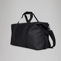 a black duffel bag on a grey background