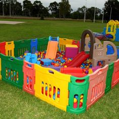 children's play area in the middle of a park with toys and slides