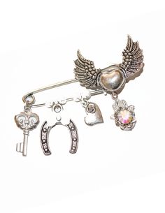 Beautiful, elegant and unique looking pin with a collection of charms for good luck, protection and love. Great as a gift of love. Delivered in a gift box. Custom orders always welcome. Suzan ♥ Unique Heart-shaped Jewelry Brooch, Spiritual Silver Brooch For Gift, Vintage Safety Pin Brooches For Gifts, Silver Safety Pin Shaped Brooch, Silver Heart Brooches For Gift, Heart-shaped Brooch Jewelry Gift, Gift Safety Pin Brooch Jewelry, Silver Safety Pin Brooches For Gifts, Silver Safety Pin Brooch As Gift