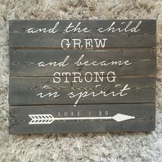 a wooden sign that says and the child grew and dreams strong in spirit