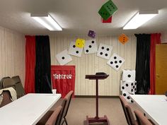 a room filled with tables and chairs covered in dominos on the wall above them