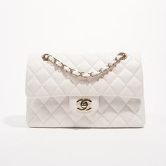 Brand: Chanel Style: Classic Flap Size: Small Width: 23.5 cm Height: 15 cm Depth: 7 cm Handle Drop: 24 - 44 cm Condition: As New Exterior Colour: White Interior Colour: White Hardware Colour: Gold﻿Leather Type: Caviar (Grained Calfskin) Serial Code: 30****** Manufactured In: France | 2020 Comes With:﻿ , Dustbag and Luxe Collective DustbagDelivery 5-8 or 10-15 working days Please note that during high season and Sale period, delivery times may be affected We accept payment with a Credit card, Deb Vintage Chanel Bag, White Hardware, Dream Bag, Chanel White, Chanel Style, Future Wardrobe, Interior Colour, Bag Collection, Chanel Jewelry