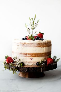 a cake with berries and greenery on top is displayed in the instagram page