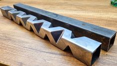 a metal object sitting on top of a wooden table