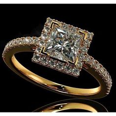 an engagement ring with a princess cut diamond surrounded by small diamonds on the band and shoulders