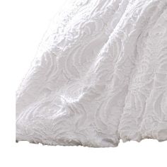 a white bed spread with an intricate design on it