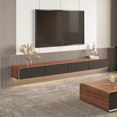 a living room with a large flat screen tv mounted on the wall next to a wooden coffee table