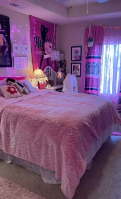 a bedroom decorated in pink and white with pictures on the wall above the bed, along with carpeted flooring