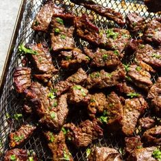 steak on a grill with parsley garnish