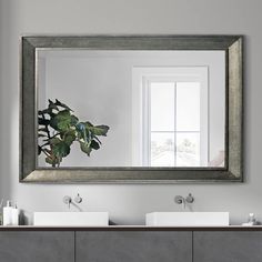 a bathroom with two sinks and a large mirror