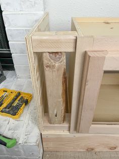 the unfinished cabinets are being assembled and ready to be painted