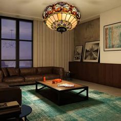 a living room filled with furniture and a stained glass light fixture hanging from the ceiling