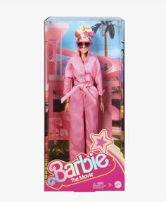 barbie the movie barbie doll in pink outfit with sunglasses and stars on her head, standing in front of a palm tree