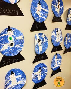 a bulletin board with snowmen on it and name tags attached to the back of them