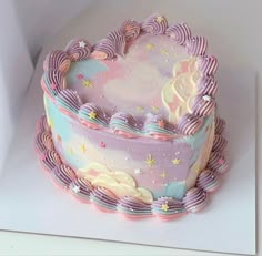 there is a cake that looks like it has been decorated with pastel icing