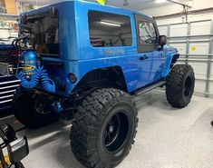 a large blue truck parked in a garage