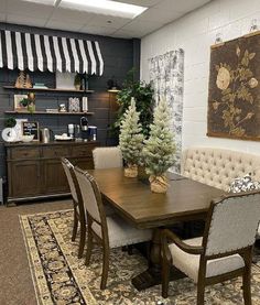 a dining room table with chairs and a bench in front of an area rug that has a christmas tree on it