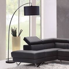 a living room with a couch, chair and floor lamp