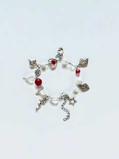 This handmade beaded charm bracelet is a simple but chic addition to any outfit. The bracelet features high quality glass beads and stainless steel charms, making it durable and non-tarnish. The red and silver accents offer a stylish and classic look. Beaded Charm Bracelet, Red Charm, Red And Silver, Bead Charm Bracelet, Red Bead, Silver Accents, Charm Bracelets, Bracelet Making, Classic Looks