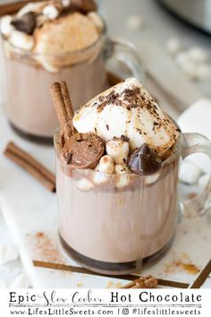 two mugs filled with hot chocolate and marshmallows