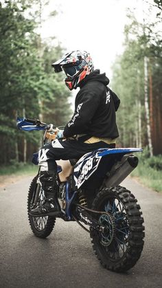 a man riding on the back of a dirt bike