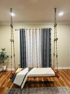 a living room with a swing bed and rugs