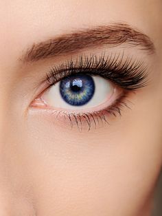 a woman's blue eye with long lashes