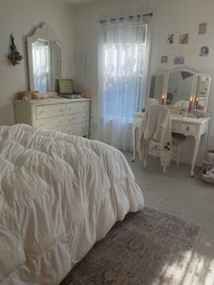 a bedroom with a bed, dresser and dressing table in it's center area