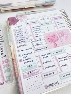 a planner with pink and green stickers on it next to a notebook full of notes