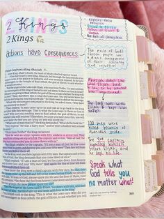 an open bible with colorful writing on the pages and pink furnishing behind it