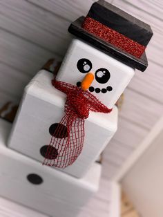 a snowman made out of toilet paper on top of a shelf