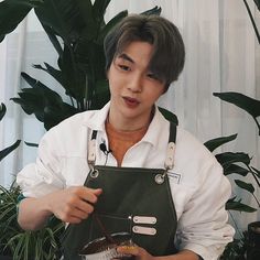 a young man holding a pot with food in it