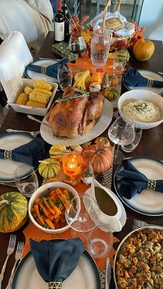 a table is set for thanksgiving dinner with turkey and vegetables