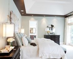 a bedroom with white bedding and blue walls