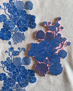 some blue and pink flowers on a white cloth