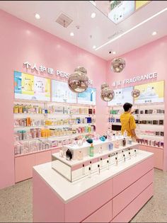 a store filled with lots of different types of cosmetics and perfume bottles on display in front of the counter