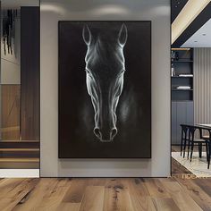 a black and white photo of a horse's head hanging on a wall in a living room