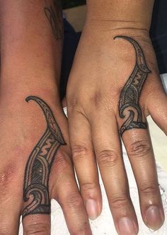 two people with matching tattoos on their hands