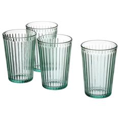 four green glass tumblers sitting next to each other