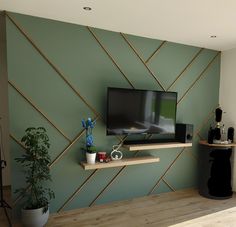 a flat screen tv sitting on top of a wooden shelf next to a potted plant