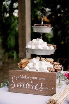 a wooden sign that says make your own s'mores on top of a table