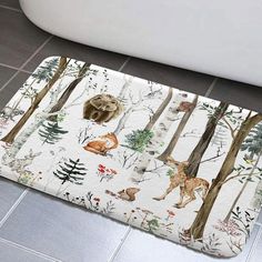 a bathroom rug with animals and trees on it