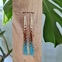 "Embrace your inner bohemian goddess with our fan favorite long fringe beaded earrings - but in a more glossy finish bead (compared to the usual matte beads that I use). Beautifully dramatic, comfortably lightweight. Enjoy the playful, free flowing style of beaded fringe earrings, without the weight.  Featuring 4 strands of hand woven matte glass beads. These unique matte glass beads have a very luxe look and feel to them.  Colors: These beaded earrings feature an ombre fade of matte ivory, rust & turquoise glass beads. Length: Approximately 4\" drop length Metal: 14K Gold Filled or Sterling Silver (Gold-filled jewelry has 100x more gold alloy than gold plated and because that layer is so much thicker, it means gold-filled jewelry lasts longer and stands up to wear and tear better than gol Bohemian Beaded Tassel Earrings, Bohemian Adjustable Tassel Earrings With Fringe, Adjustable Bohemian Tassel Earrings With Fringe, Brown Bohemian Tassel Earrings, Bohemian Brown Tassel Earrings, Bohemian Beaded Earrings With Tassels For Beach, Bohemian Beaded Earrings With Latkans For Beach, Bohemian Beaded Latkans Earrings For Beach, Bohemian Beaded Latkan Earrings For Beach