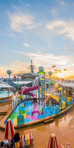 an outdoor play area on the deck of a cruise ship, with children's slides and water toys