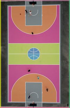 an overhead view of a basketball court with people playing on it and one person standing in the middle